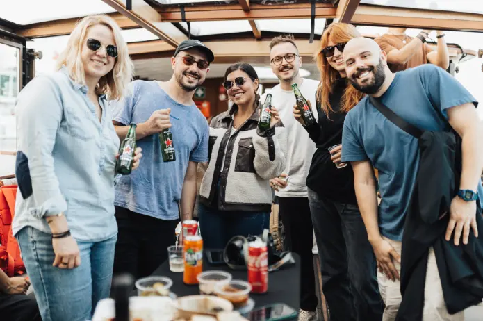 a group of people enjoying a drink and smiling at the camera
