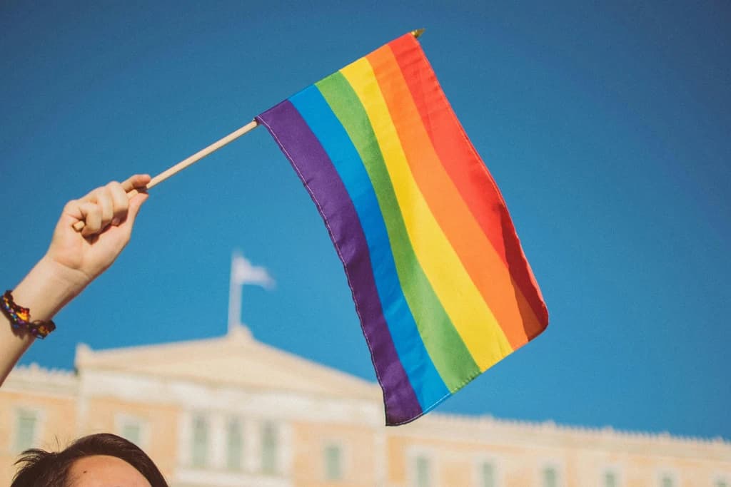 someone waiving a small pride flag