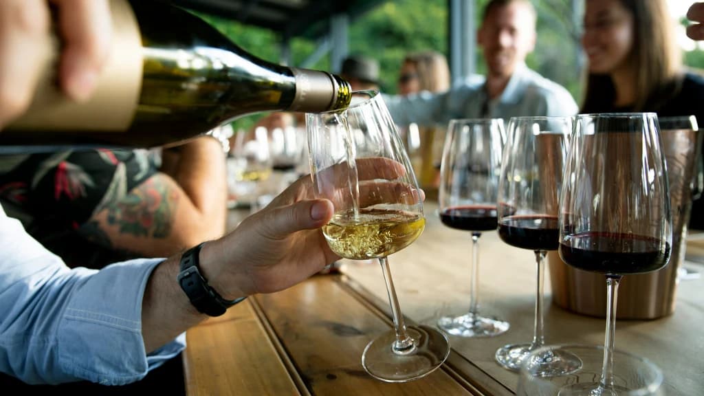 someone pouring glasses of wine
