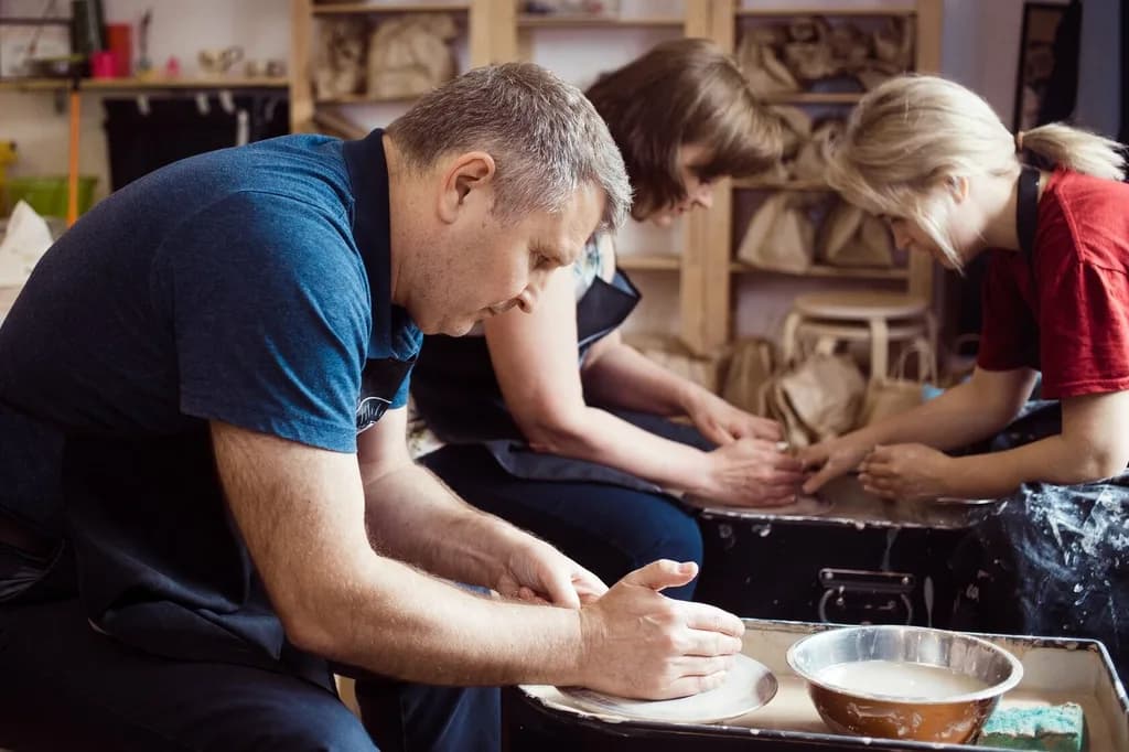 a man making something on a pottery wheel
