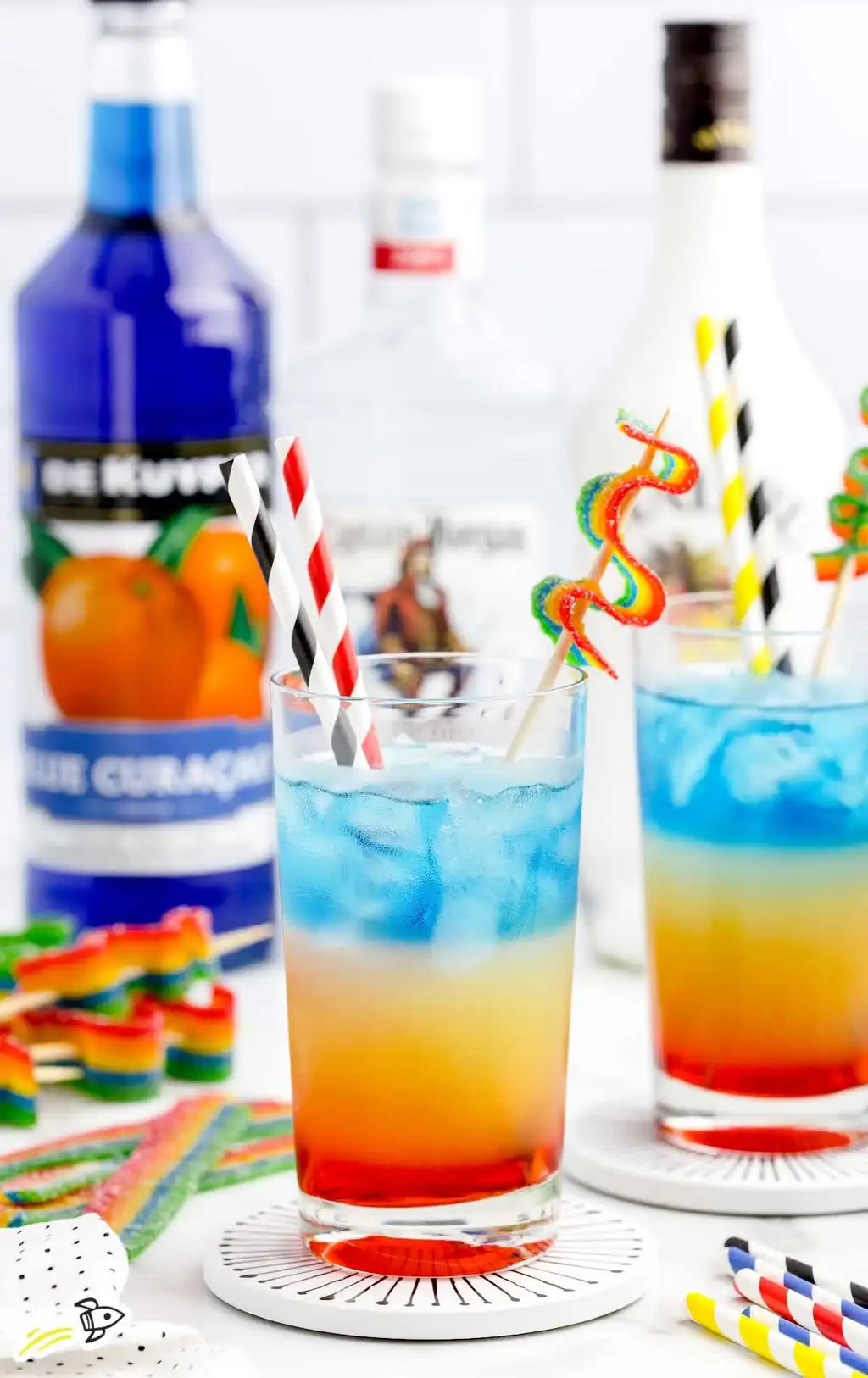 a cocktail with different colored layers in a glass