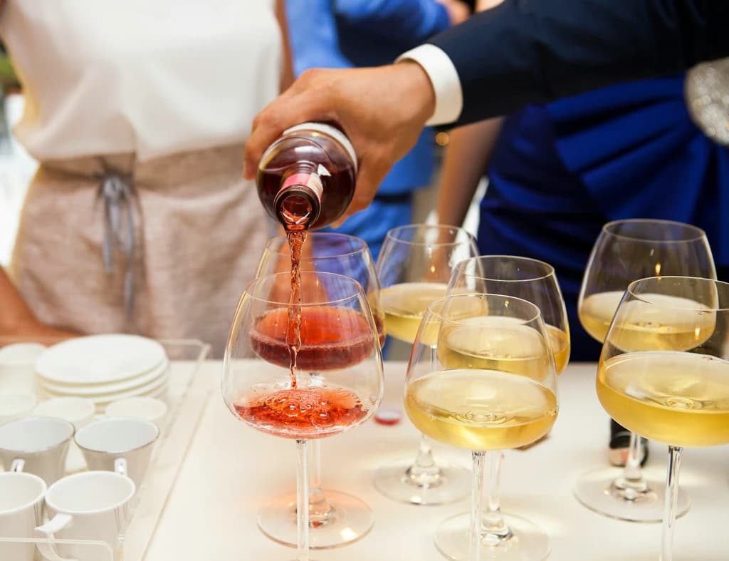 someone pouring glasses of wine