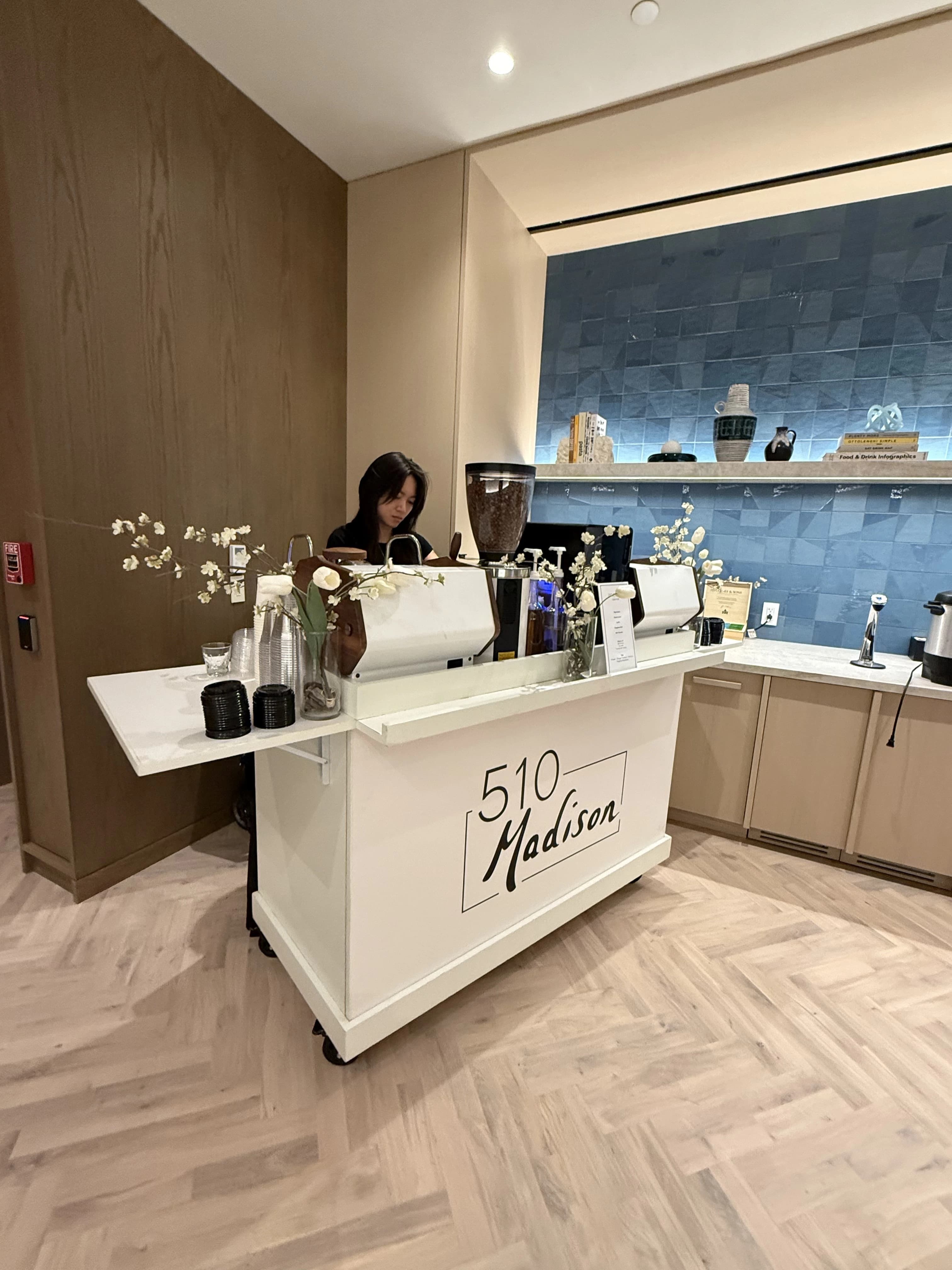 510 Madison branded coffee cart with barista preparing drinks